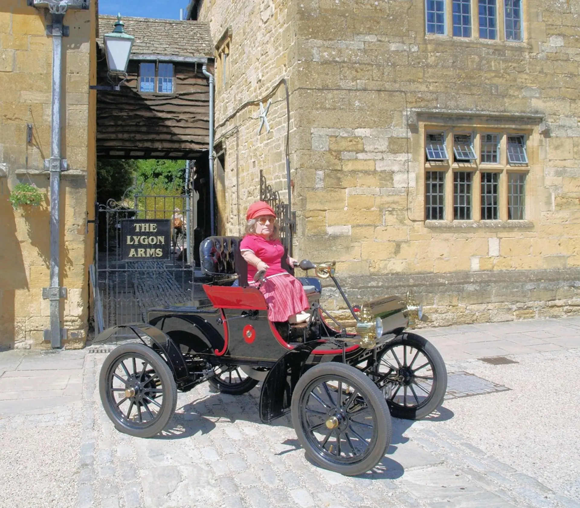 Joy Rainey in her 109-year old Oldsmobile